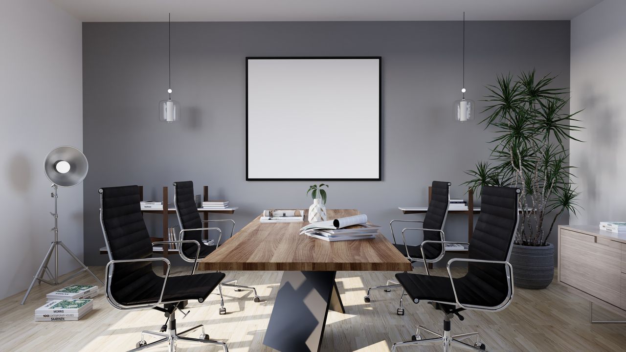 contact-img Sleek and modern conference room with minimalist design featuring stylish furniture and indoor plants.